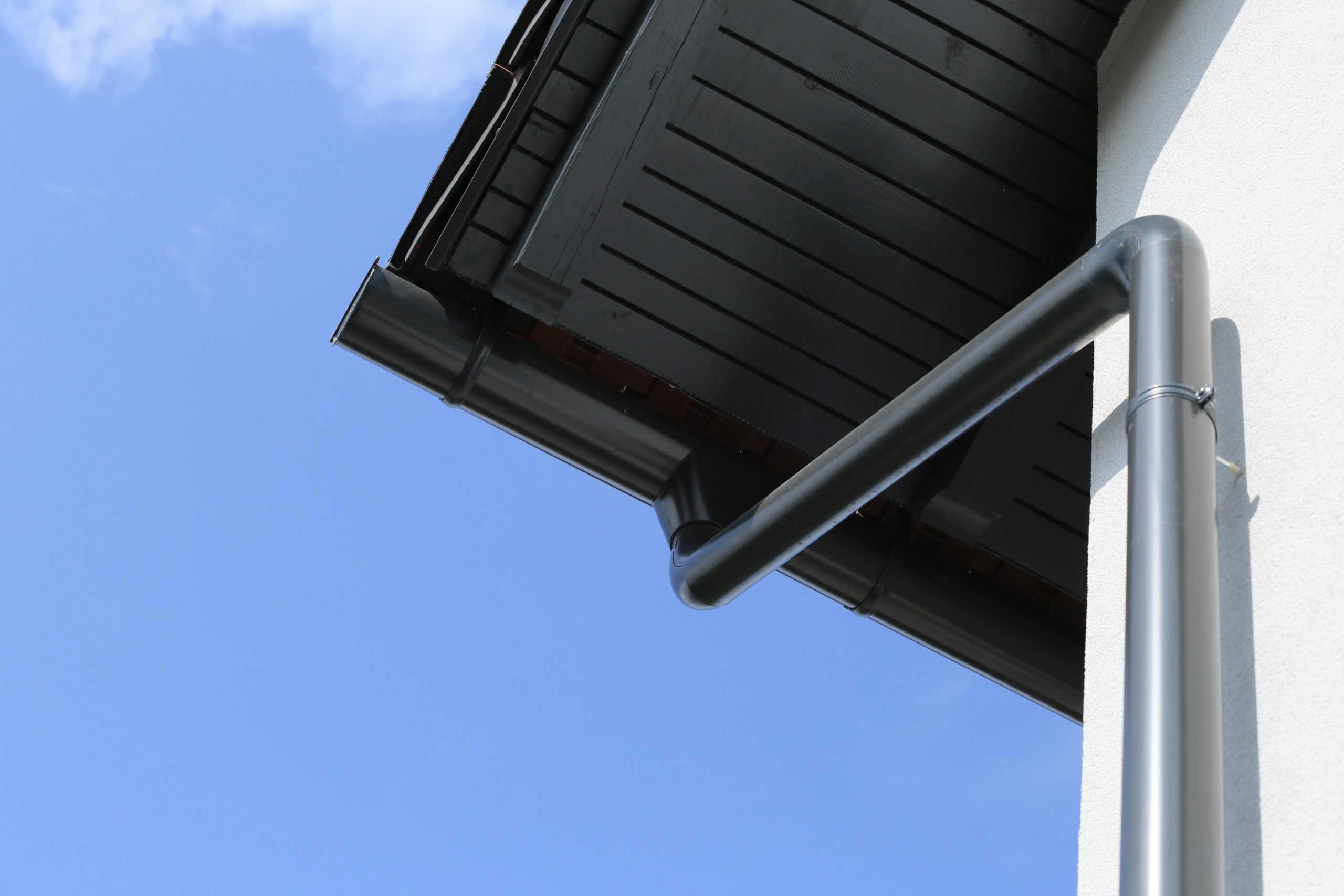 Anthracite rain drain from roof of house